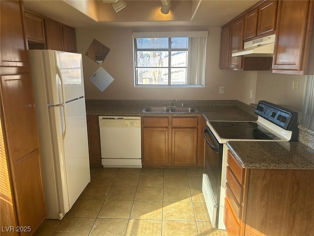 kitchen featuring light tile patterned flooring, white appliances, and sink