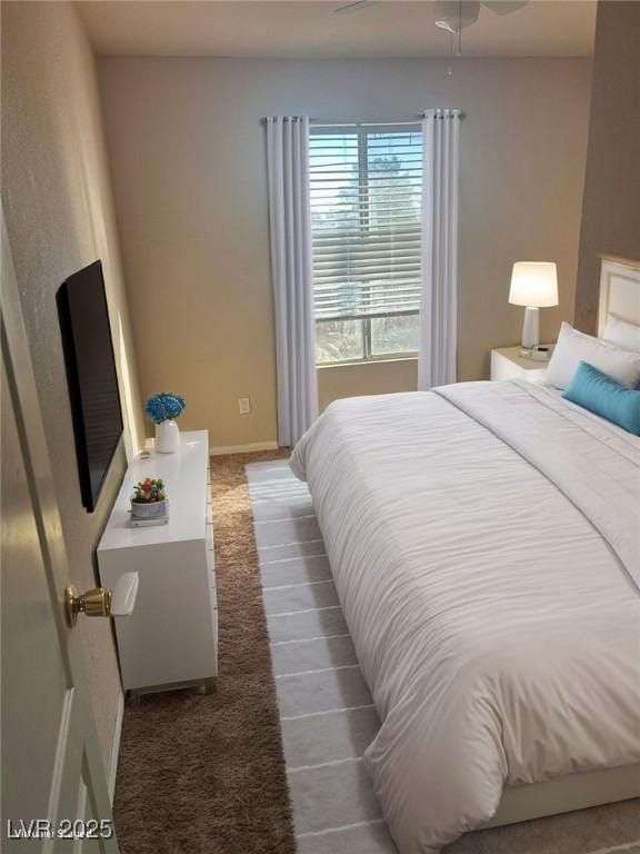 bedroom featuring ceiling fan and dark colored carpet