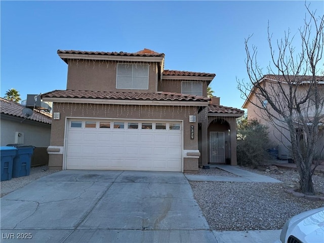 view of front of property featuring stucco siding, a tiled roof, and concrete driveway