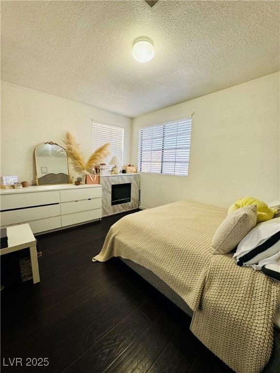 bedroom with a textured ceiling and hardwood / wood-style floors