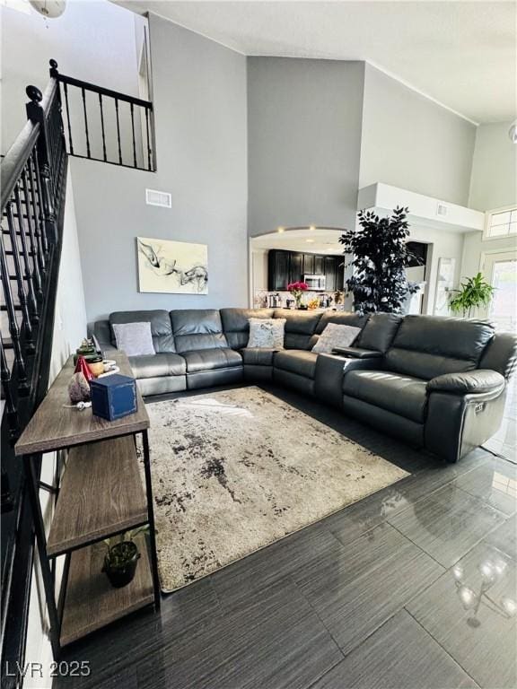 living room featuring a towering ceiling