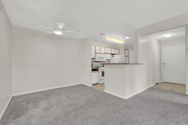 unfurnished living room with ceiling fan, light colored carpet, and a textured ceiling