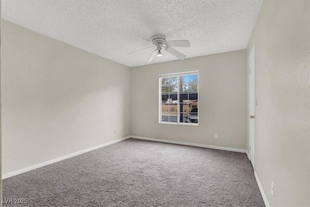 empty room featuring ceiling fan, carpet, and a textured ceiling