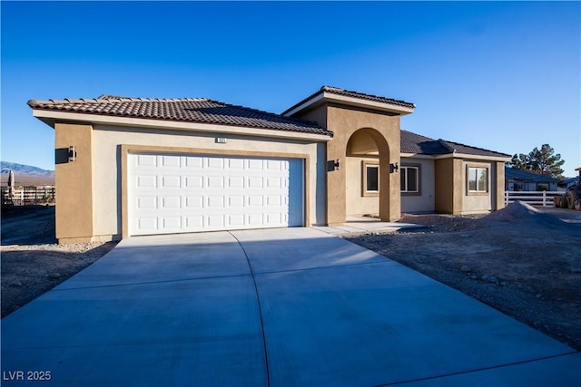 mediterranean / spanish-style home featuring a garage