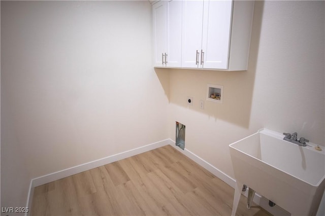 washroom with cabinet space, baseboards, light wood-style flooring, hookup for an electric dryer, and washer hookup