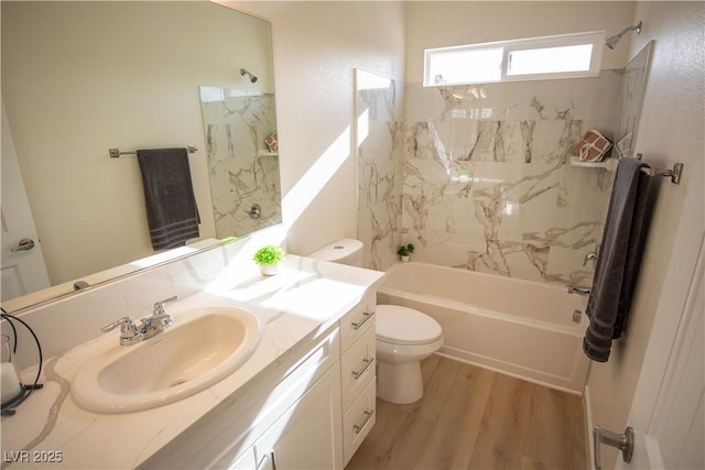 bathroom with vanity, shower / washtub combination, wood finished floors, and toilet