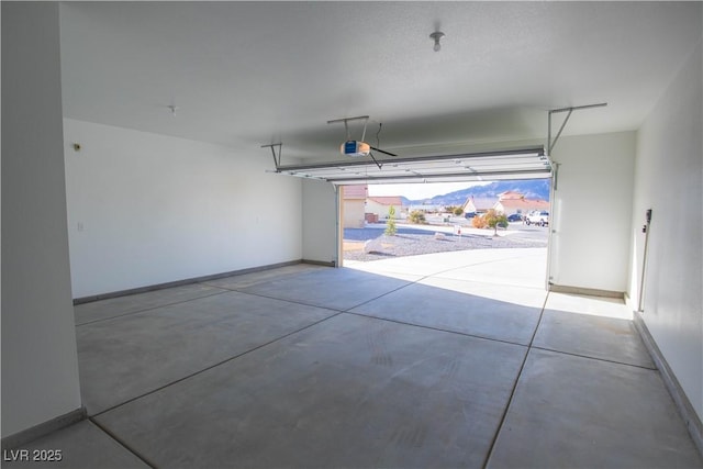 garage featuring baseboards and a garage door opener