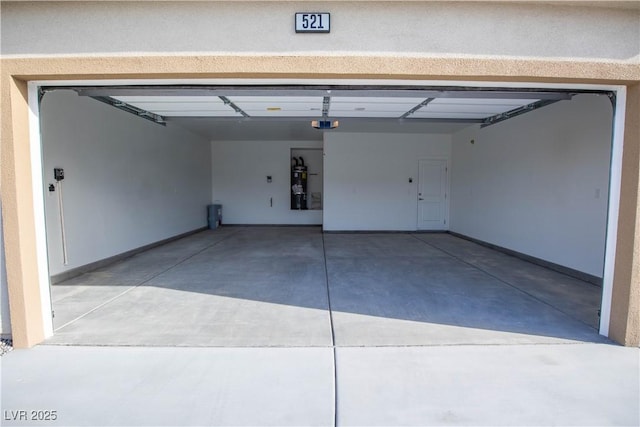 garage with strapped water heater, baseboards, and a garage door opener