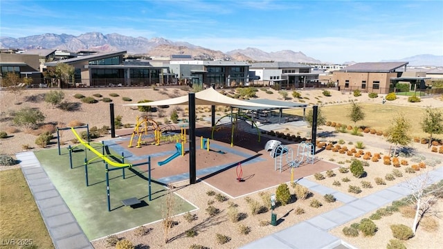 surrounding community with a playground and a mountain view