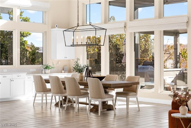 sunroom featuring a notable chandelier