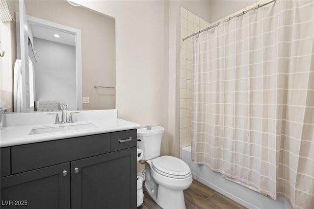 full bathroom with shower / tub combo, vanity, hardwood / wood-style flooring, and toilet