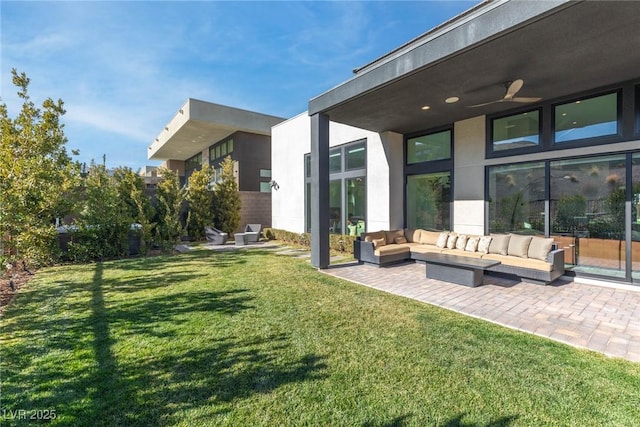 view of yard featuring an outdoor hangout area, ceiling fan, and a patio area