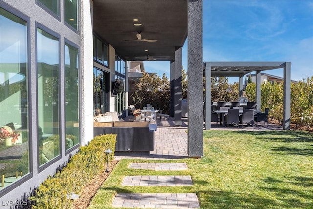 view of yard featuring an outdoor hangout area, a patio, and ceiling fan