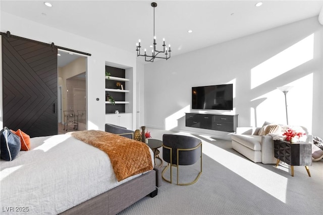 carpeted bedroom featuring a barn door and a notable chandelier