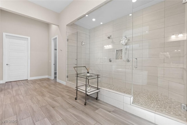 bathroom featuring a shower with door