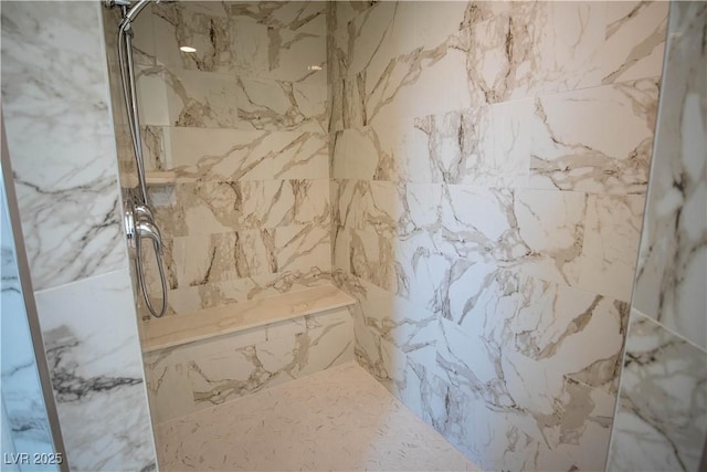 bathroom with a marble finish shower