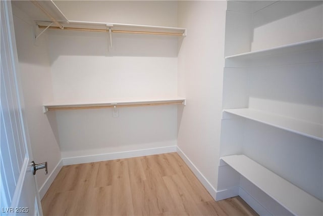 spacious closet with wood finished floors