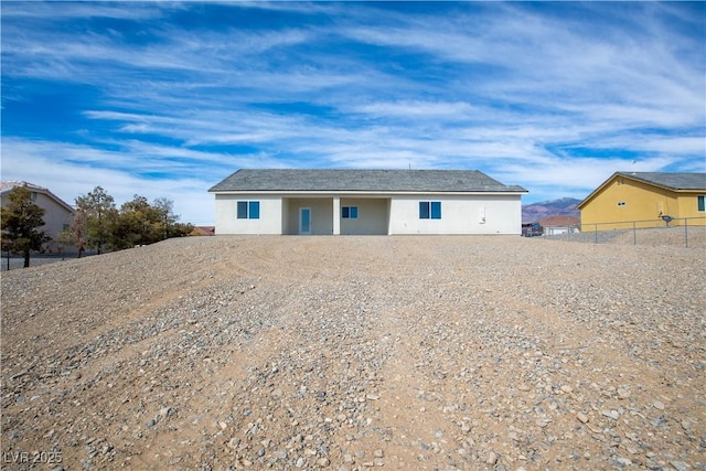 view of front of property with stucco siding and fence