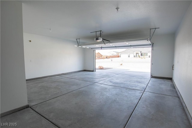 garage featuring baseboards and a garage door opener