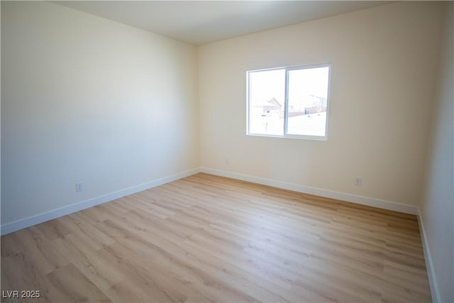 unfurnished room featuring light wood finished floors and baseboards