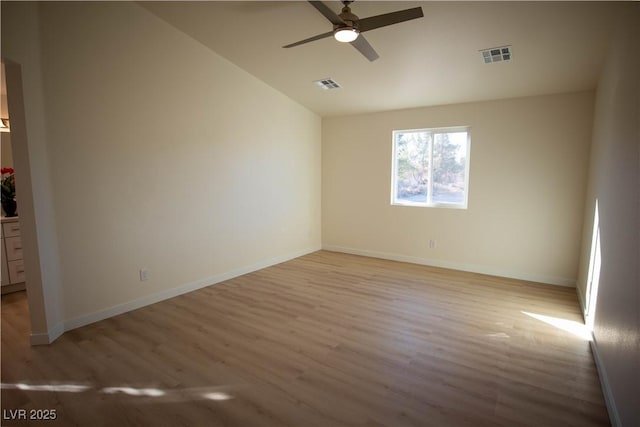 unfurnished room with visible vents, light wood-style flooring, and baseboards