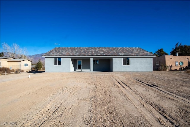 single story home with a mountain view and stucco siding