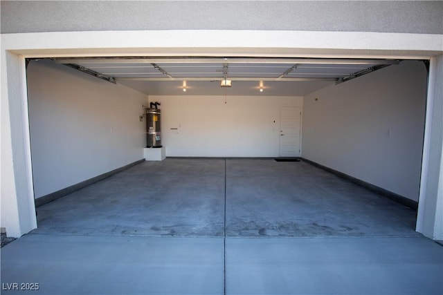 garage featuring secured water heater and baseboards