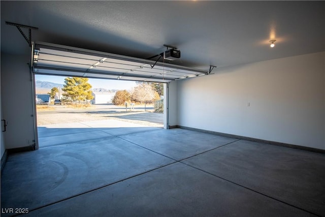 garage with a garage door opener and baseboards