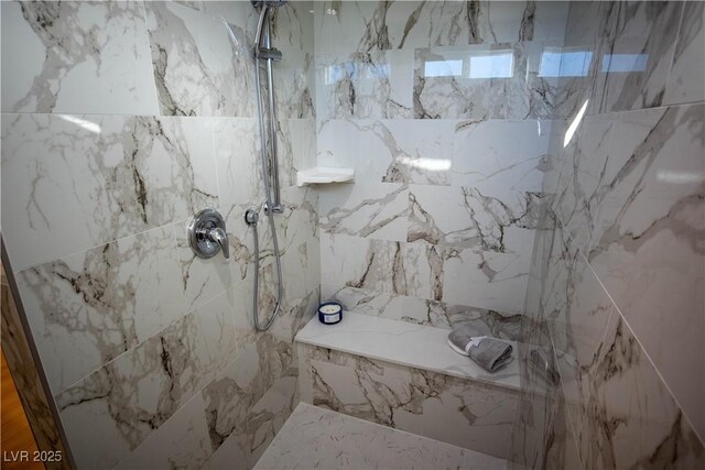 full bath featuring a marble finish shower