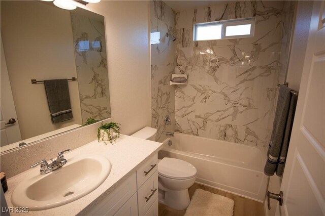 full bathroom featuring toilet, vanity, wood finished floors, and shower / bathtub combination