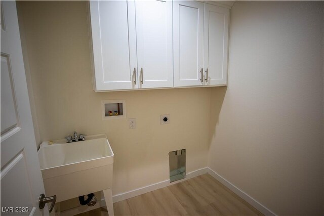 laundry room featuring hookup for a washing machine, cabinet space, hookup for an electric dryer, a sink, and light wood-type flooring