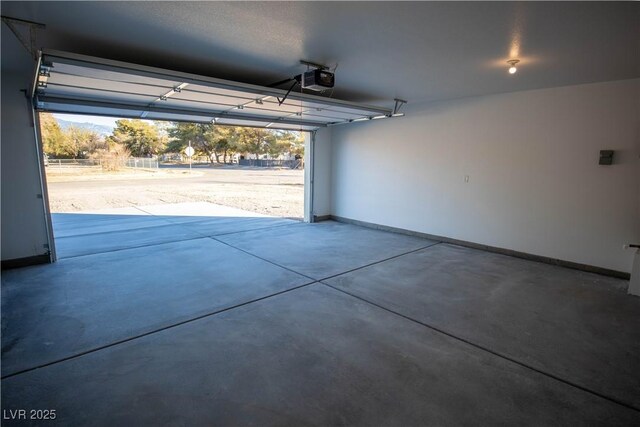 garage with a garage door opener and baseboards