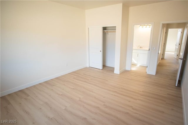 5821 Genoa Ave, Pahrump, NV 89060 - unfurnished bedroom with baseboards, a sink, light wood-style floors, and a closet