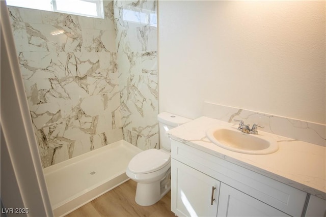 5821 Genoa Ave, Pahrump, NV 89060 - bathroom featuring a shower stall, toilet, vanity, and wood finished floors