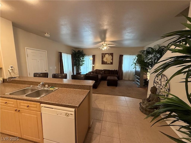 kitchen featuring white dishwasher, sink, light tile patterned floors, and ceiling fan