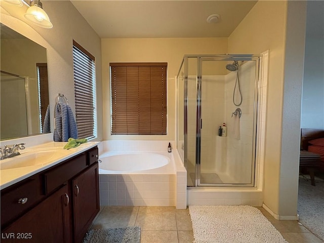 bathroom featuring a bath, tile patterned flooring, a shower stall, and vanity