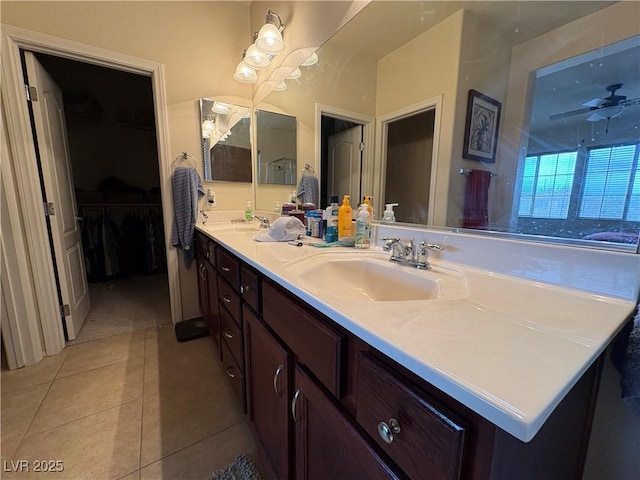 bathroom featuring a sink, a ceiling fan, double vanity, and tile patterned flooring