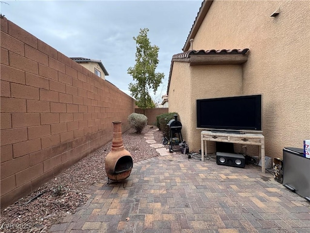 view of patio / terrace featuring a grill, a fenced backyard, and an outdoor fire pit