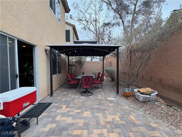 view of patio / terrace with a gazebo, outdoor dining area, and a fenced backyard