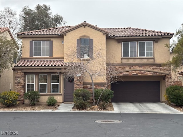 mediterranean / spanish-style home featuring concrete driveway, a garage, stone siding, and stucco siding