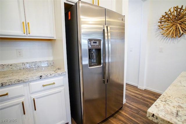 kitchen featuring white cabinetry, stainless steel fridge with ice dispenser, dark wood-type flooring, and light stone countertops