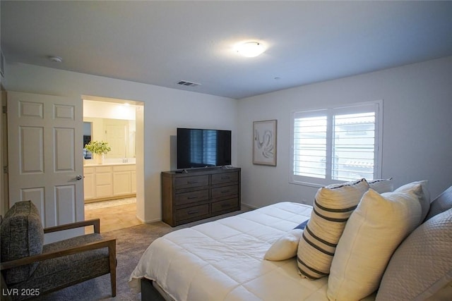 carpeted bedroom featuring connected bathroom