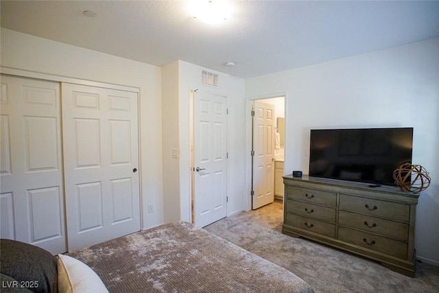 bedroom with light colored carpet and a closet