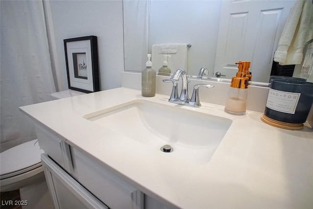 bathroom featuring vanity and toilet