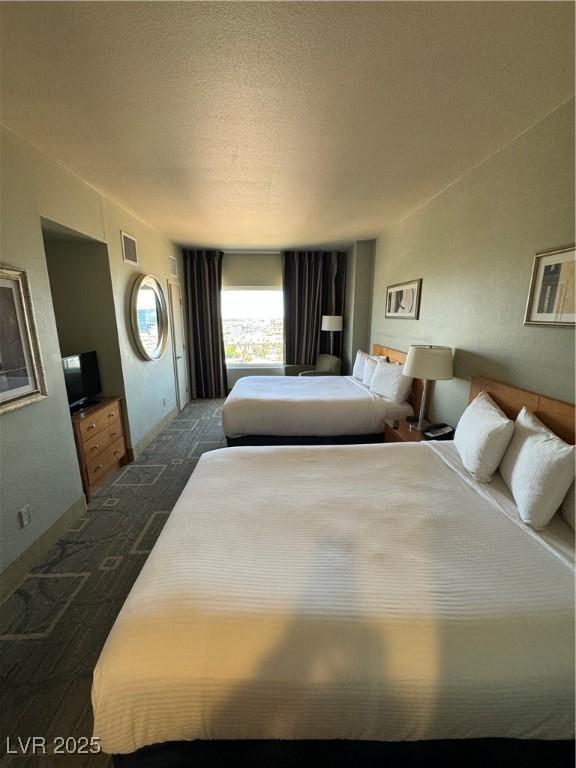 carpeted bedroom with a textured ceiling