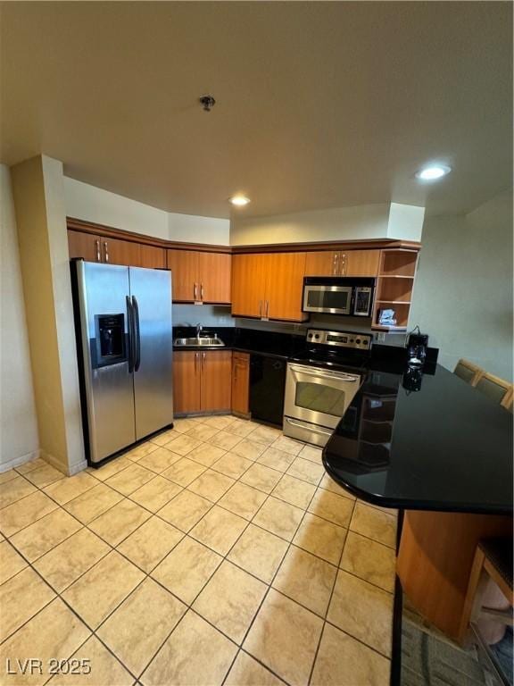 kitchen featuring light tile patterned flooring, appliances with stainless steel finishes, and sink