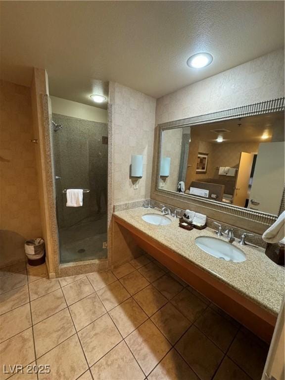 bathroom with an enclosed shower, vanity, and tile patterned floors