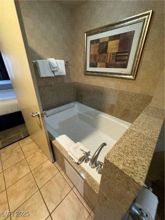 bathroom featuring tile patterned floors and tiled bath