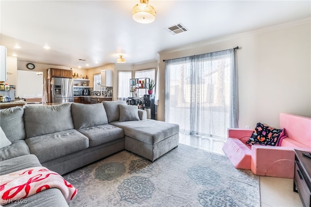 tiled living room featuring crown molding