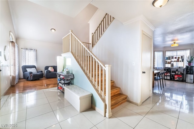 staircase featuring tile patterned flooring and crown molding